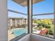 Bright view of community pool and landscaping seen through multi-paned window at 19777 N 76Th St # 3220, Scottsdale, AZ 85255
