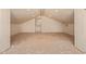 Attic interior featuring bright natural light, dormer windows, and fresh white paint at 2131 E Rose Garden Ln, Phoenix, AZ 85024