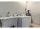This laundry room features a stainless steel sink, washer, and dryer at 2131 E Rose Garden Ln, Phoenix, AZ 85024