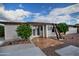 Backyard view of property showcasing tiled patio and lush landscaping at 228 N 65Th Pl, Mesa, AZ 85205