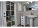 Bathroom vanity with white sink, mirror and storage cabinet at 228 N 65Th Pl, Mesa, AZ 85205