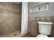 Shower and toilet in the bathroom with decorative tile at 228 N 65Th Pl, Mesa, AZ 85205