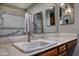 Bathroom vanity with a white sink, mirror, and wood cabinets at 228 N 65Th Pl, Mesa, AZ 85205