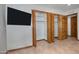 Bedroom walk-in closet with folding doors and neutral wall at 228 N 65Th Pl, Mesa, AZ 85205