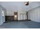 View of a spacious garage with concrete flooring, storage cabinets, and a water heater at 228 N 65Th Pl, Mesa, AZ 85205