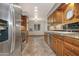 Charming kitchen featuring tile floors, wooden cabinets and stainless steel appliances at 228 N 65Th Pl, Mesa, AZ 85205