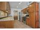 Kitchen with stainless steel appliances, wood cabinets, and eat-in kitchen at 228 N 65Th Pl, Mesa, AZ 85205