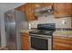 Kitchen view featuring stainless steel refrigerator and stovetop oven at 228 N 65Th Pl, Mesa, AZ 85205
