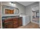 Laundry room with double vanity, mirror, washer, and dryer at 228 N 65Th Pl, Mesa, AZ 85205