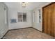 Well-lit room features tile flooring, window unit, and a solid-core door at 228 N 65Th Pl, Mesa, AZ 85205