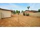 Expansive dirt backyard with storage shed, block wall, and mature trees at 2320 W El Alba Way, Chandler, AZ 85224