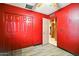 Bedroom featuring red walls, closet with folding doors, and an entry door at 2320 W El Alba Way, Chandler, AZ 85224