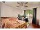 Bedroom with large window, ceiling fan, and carpet flooring at 2320 W El Alba Way, Chandler, AZ 85224