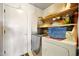 Functional laundry room with washer, dryer, built-in shelving and a nearby door at 2320 W El Alba Way, Chandler, AZ 85224