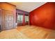 View of the living room with colorful accent wall and wood-look tile floor at 2320 W El Alba Way, Chandler, AZ 85224
