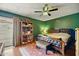 Comfortable main bedroom featuring a ceiling fan, hardwood floors, and a bookshelf at 2320 W El Alba Way, Chandler, AZ 85224
