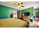 Cozy main bedroom with wood floors, a ceiling fan, plenty of natural light, and ample closet space at 2320 W El Alba Way, Chandler, AZ 85224