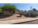 Spacious side yard with drought-tolerant landscaping, mature trees, and block wall fencing at 2320 W El Alba Way, Chandler, AZ 85224