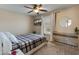Cozy bedroom with a window, ceiling fan, and desk, perfect for relaxing or working from home at 2331 E Sunland Ave, Phoenix, AZ 85040