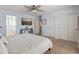 Bright bedroom featuring a ceiling fan, television, and neutral carpet, creating a cozy and inviting atmosphere at 2331 E Sunland Ave, Phoenix, AZ 85040