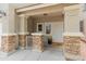 Inviting front porch with decorative pillars, stone accents, and a secure pet gate at 2331 E Sunland Ave, Phoenix, AZ 85040