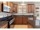 Kitchen featuring granite countertops, stainless steel appliances, and a breakfast bar at 2331 E Sunland Ave, Phoenix, AZ 85040