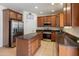 Well-lit kitchen featuring stainless steel appliances, ample counter space, and wooden cabinetry at 2331 E Sunland Ave, Phoenix, AZ 85040