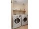 Efficient laundry room featuring a washer and dryer, with storage shelves, for easy organization and convenience at 2331 E Sunland Ave, Phoenix, AZ 85040