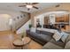 Spacious living room with tile flooring, ceiling fan, and an open view of the staircase at 2331 E Sunland Ave, Phoenix, AZ 85040
