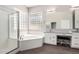 Bright bathroom with a separate shower and tub, dual sinks, a vanity, and wood-look tile flooring at 2409 W Red Range Way, Phoenix, AZ 85085