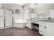 Bright bathroom featuring a separate shower and tub, dual sinks, a vanity, and wood-look tile flooring at 2409 W Red Range Way, Phoenix, AZ 85085