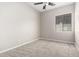 Neutral bedroom with ceiling fan and window providing natural light at 2409 W Red Range Way, Phoenix, AZ 85085