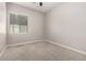 Neutral bedroom with ceiling fan and window providing natural light at 2409 W Red Range Way, Phoenix, AZ 85085