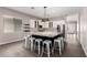 Bright kitchen with large island, white cabinets, granite countertops, stainless steel appliances, and wood-look tile flooring at 2409 W Red Range Way, Phoenix, AZ 85085