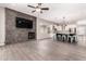 Open-concept living area featuring modern finishes, wood look tile floors, and a fireplace feature wall at 2409 W Red Range Way, Phoenix, AZ 85085