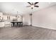 Spacious living area with wood-look tile flooring next to the kitchen with an open floor plan at 2409 W Red Range Way, Phoenix, AZ 85085