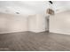 Open living room with wood look tile, recessed lighting and a decorative light fixture at 2409 W Red Range Way, Phoenix, AZ 85085