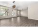 Open living room featuring wood look tile floors, a modern light fixture, and bright natural light at 2409 W Red Range Way, Phoenix, AZ 85085
