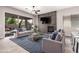 Cozy living room featuring a fireplace, tile accent wall, modern furniture, and sliding glass doors to the patio at 2409 W Red Range Way, Phoenix, AZ 85085