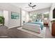 Bright bedroom with a ceiling fan, a large window for natural light, and an ensuite bathroom at 2409 W Red Range Way, Phoenix, AZ 85085