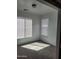 Bright bedroom with carpet flooring, two windows and mini blinds for natural light at 26022 N Sandstone Way, Surprise, AZ 85387