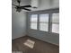 Bedroom featuring carpet flooring, a ceiling fan and three windows for natural light at 26022 N Sandstone Way, Surprise, AZ 85387