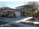 Beautiful two story home featuring a manicured front yard and an attached two car garage at 26022 N Sandstone Way, Surprise, AZ 85387