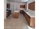 A spacious kitchen featuring stainless steel appliances, an island, and tile flooring at 26022 N Sandstone Way, Surprise, AZ 85387
