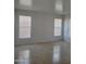 Living room showcasing tile flooring, multiple windows, and abundant natural light at 26022 N Sandstone Way, Surprise, AZ 85387