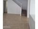 Bright living room showcasing tile flooring and a staircase with carpeted steps at 26022 N Sandstone Way, Surprise, AZ 85387