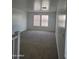 Bright living room featuring carpet flooring and multiple windows at 26022 N Sandstone Way, Surprise, AZ 85387