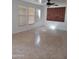 Open concept living room featuring neutral walls and tile floors bathed in natural light from large windows at 26022 N Sandstone Way, Surprise, AZ 85387