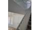 Staircase with white railing, carpeted steps, and a view of the front door at 26022 N Sandstone Way, Surprise, AZ 85387