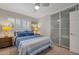 Bedroom with blue bedding, wood bedside tables and sliding mirror closet doors at 2656 N 84Th Pl, Scottsdale, AZ 85257